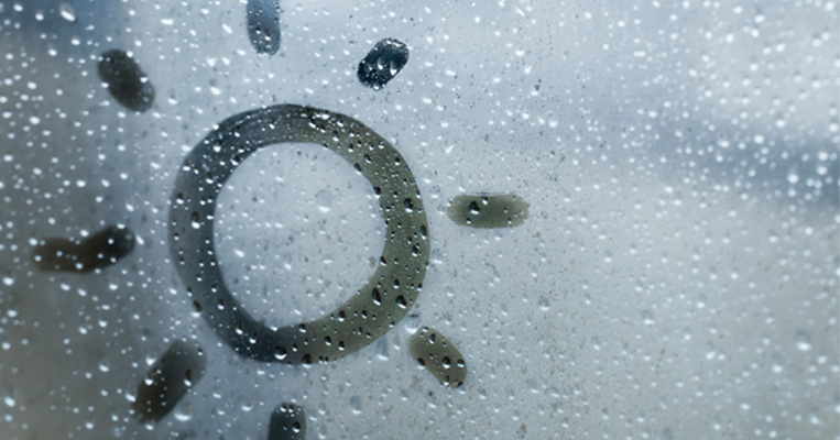 Sun drawing on window condensation