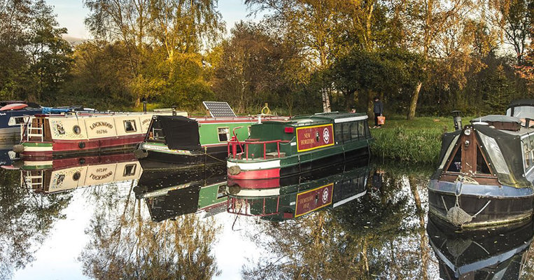 Boats docked alongside river