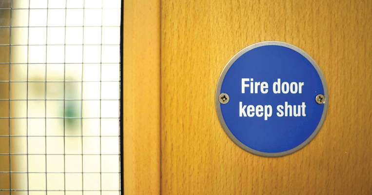 Fire door keep shut sign on door