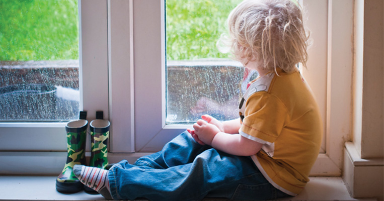 Child looking outside window