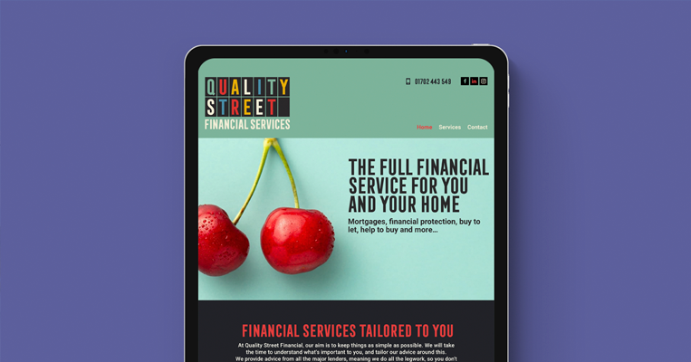 iPad tablet showcasing the Quality Financial Services website
